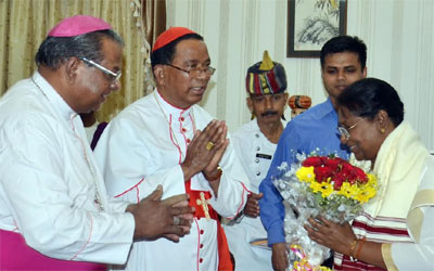 Governor Droupadi Murmu receives bouquet from Cardinal Telespher P Toppo